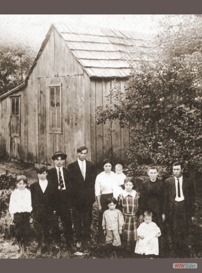 John & Malissa Baker & family in front of old home